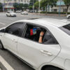 14 inch Android taxi headrest display installed on a vehicle seat for passenger advertising.
