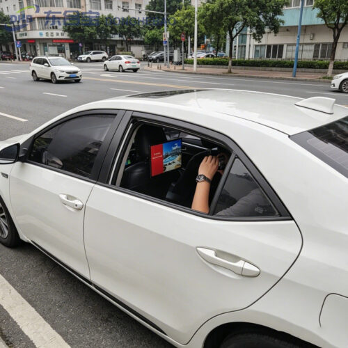 14 inch Android taxi headrest display installed on a vehicle seat for passenger advertising.